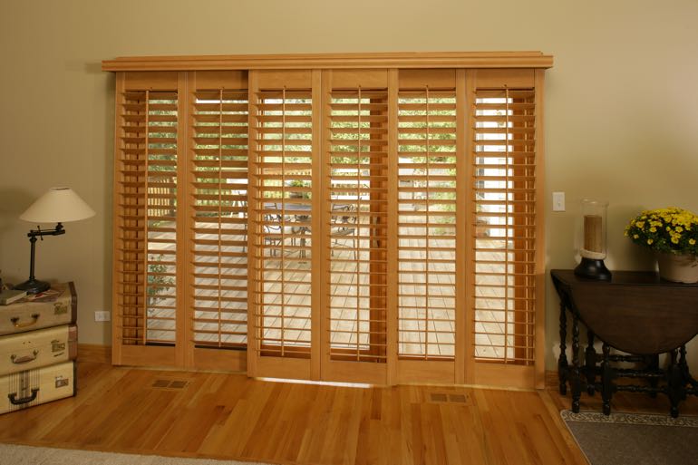 Faux wood shutters on sliding door leading to back porch.